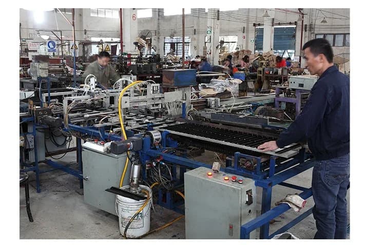 Workers and production machinery inside the WANYILONG workshop